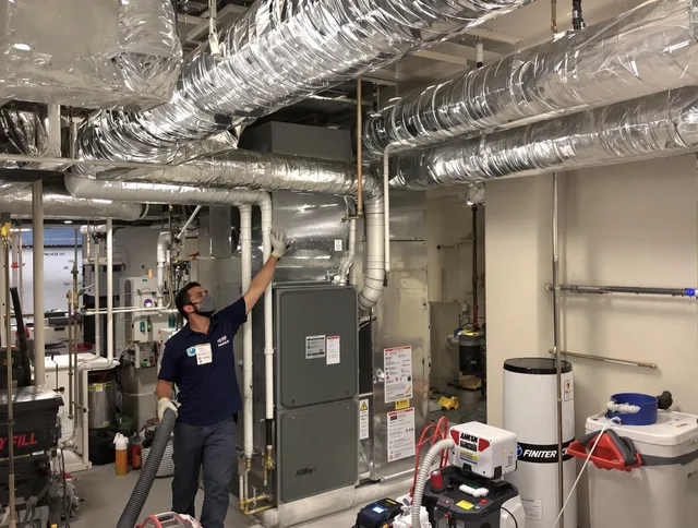 Sharon Air Duct Cleaning specialist performing thorough furnace duct cleaning in a Sharon residence