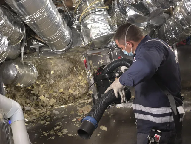 Sharon Air Duct Cleaning specialist operating negative pressure cleaning equipment for thorough duct maintenance in Sharon
