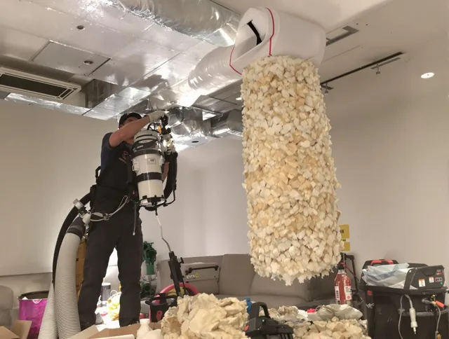 Sharon Air Duct Cleaning technician performing precision vacuum insulation removal in a residential property in Sharon